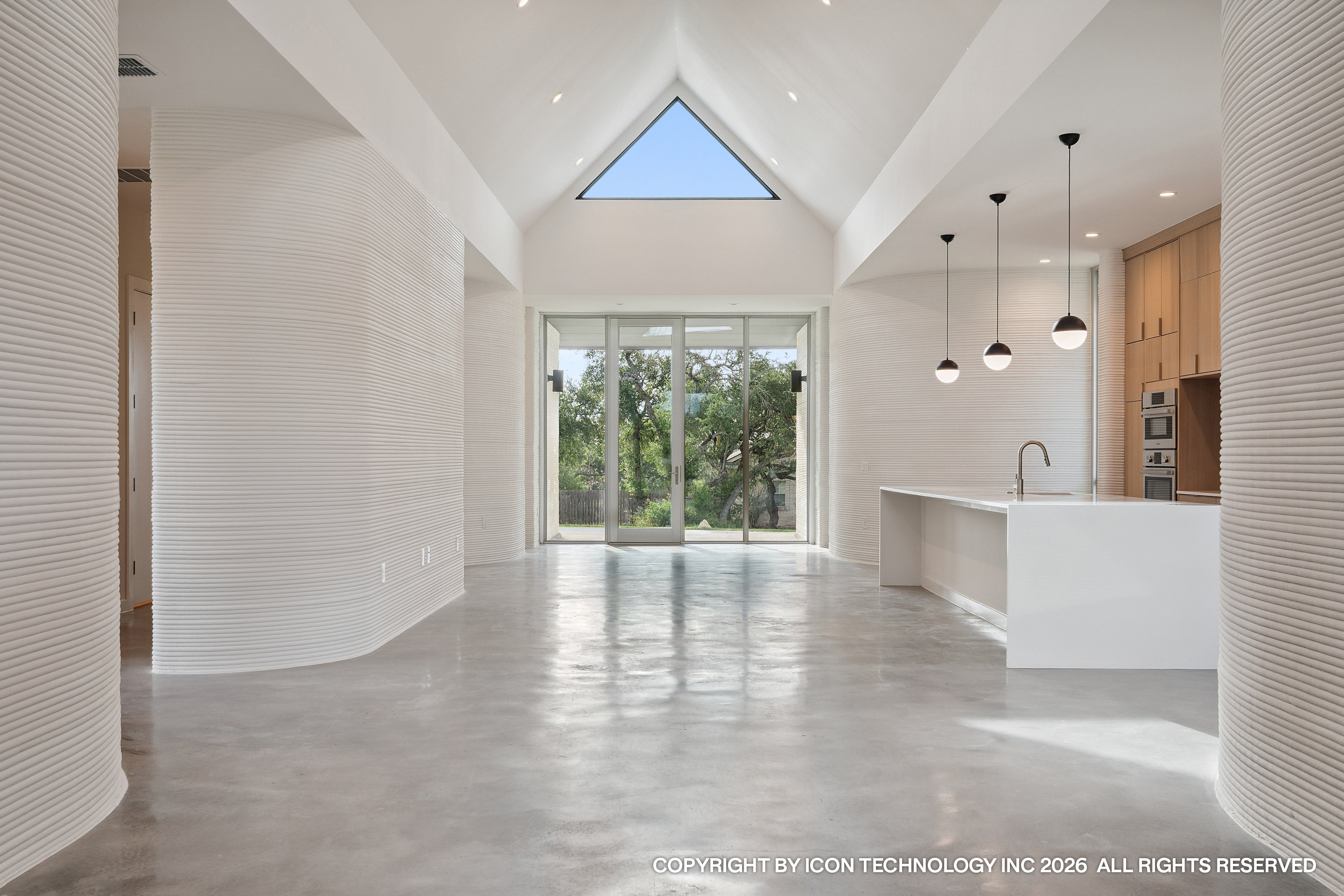 Vaulted great room with triangle skylight and curved printed walls